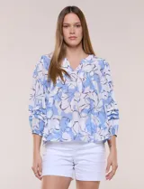 Blusa holgada de gasa estampada en tonos amarillos y azules, con cuello en V, mangas 3/4 abullonadas y alforzas horizontales.
