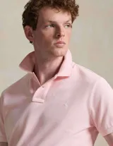 Remera polo de algodón color rosado, corte Custom Slim Fit, manga corta y cuello con botones. Cuenta con el logo bordado en el pecho.