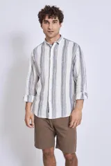 Camisa de corte regular con diseño de rayas verticales finas en tonos claros, cuello clásico y mangas largas con puños abotonados.