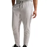 Pantalón deportivo Nike Unlimited de color negro, con cintura elástica ajustable mediante cordón, bolsillos laterales y diseño entallado hacia los tobillos.