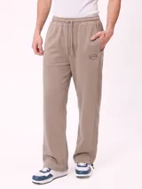 Pantalón de jogging holgado de terciopelo francés, color marrón claro, con cintura elástica con cordón ajustable y bolsillos laterales.