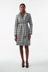 Tapado corto de tweed a cuadros blanco y negro, con cuello solapa y cinturón.