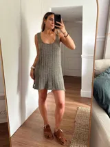 Vestido corto de tejido de punto, color marrón con hilos dorados (lurex) que le dan un brillo sutil. Diseño de tirantes anchos y escote redondo.