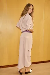 Pantalón cargo de tiro medio confeccionado en mezcla de lino. Presenta cintura con cordón ajustable, bolsillos de plastrón en el delantero y en las piernas, y bajo ajustable con cordones.