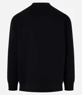 Sweater color beige de algodón y poliéster, de corte holgado, cuello redondo y mangas largas.