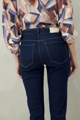 Pantalón chupín negro de tiro alto, confeccionado en denim suave y levemente elástico, con bolsillos delanteros y traseros.