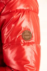 Campera puffer roja con capucha, calce al cuerpo y terminación engomada.