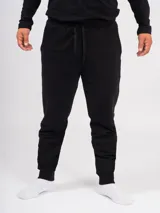 Pantalón babucha deportivo unisex azul, de tiro alto, con puños y cordones ajustables.