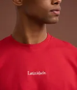 Remera de algodón roja de corte recto, con cuello redondo, mangas cortas y detalle de lettering sutil en el pecho.