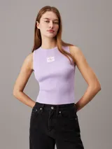 Remera sin mangas, ajustada al cuerpo, de tejido de punto acanalado color lila claro. Presenta un cuello redondo y una pequeña etiqueta tejida con el monograma de Calvin Klein Jeans en el pecho.