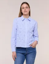 Camisa de algodón celeste con patrón de milrayas finas y aplicaciones florales en relieve deshilachado en el frente. Cuenta con cuello camisero tradicional, cierre frontal con botones, mangas largas con puños abotonados y corte semi holgado.