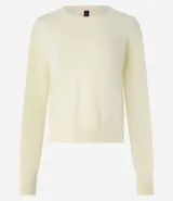 Suéter negro de punto leve, corte boxy, cuello redondo y mangas largas con puños y bajo acanalados.