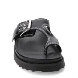 Sandalias negras Miss Carol modelo Funi, estilo dedo con plataforma baja y suela dentada. Cuenta con una tira ancha cruzada ajustable mediante una hebilla metálica grande y detalles de costuras blancas a la vista.