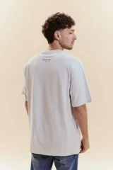 Remera de manga corta celeste con bordado en la parte posterior superior que dice 'Uruguay' en letra cursiva azul.