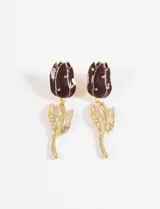 Aros colgantes con diseño de tulipán, compuestos por una flor esmaltada en color bordó con incrustaciones de cristales y un tallo metálico dorado con hojas decoradas con cristales.