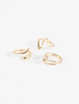 Set de tres anillos dorados de diseño ondulado y abstracto.