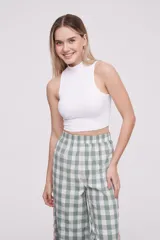 Top de punto acanalado color blanco, con cuello alto y diseño sin mangas, de corte ajustado al cuerpo.