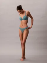 Colaless Calvin Klein Ideal Cotton color verde agua, confeccionada en mezcla de algodón elástico extra suave. Presenta cintura fina y flexible con logo de la marca en el lateral.