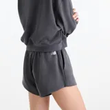 Short New Balance de felpa francesa color gris oscuro, con cintura elástica y cordón de ajuste. Cuenta con bolsillos laterales y detalle de la marca estampado y bordado en el muslo izquierdo.