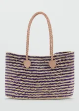 Bolso tipo shopper de diseño trenzado en fibras naturales de hoja de palma de coco, con combinación de colores violeta y natural. Cuenta con doble asa de hombro trenzada en cuero color beige y detalles de sujeción en cuero.