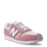 Championes urbanos New Balance modelo 373, color rosado con detalles en blanco y gris. Confeccionados en una combinación de gamuza y malla, presentan el logo 'N' característico en los laterales y una suela de goma resistente.