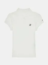 Chomba blanca de piqué de algodón regenerativo con corte slim, cuello tipo polo, cartera de dos botones, logo Tommy Hilfiger Script bordado en el pecho y bandera de Tommy Hilfiger bordada en la manga.