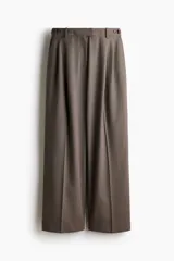 Pantalón sastrero de corte recto y perneras amplias, color marrón, con pinzas frontales, trabillas ajustables con botones en la cintura y raya marcada en el centro de las piernas.