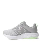 Championes de running New Balance modelo 460, color gris con detalles en verde claro y suela blanca. Presentan diseño de malla transpirable y cierre con cordones.