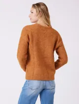 Buzo de lana melange color tostado, con cuello redondo y mangas largas.