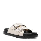 Sandalias Miss Carol modelo Brix, color marfil, con dos tiras cruzadas ajustables mediante hebillas metálicas plateadas y suela plana de goma negra.