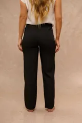 Pantalón negro de vestir de corte recto y tiro alto con trabillas para cinturón y bolsillos laterales.