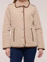 Campera matelaseada Michael Kors, de color beige con ribetes de ecocuero marrón. Cuenta con cuello con solapa, cierre frontal con broches metálicos, bolsillos laterales con cierre y mangas largas.