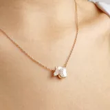 Collar de cadena fina plateada con un dije en forma de mariposa, donde una mitad está decorada con cristales brillantes y la otra mitad presenta un acabado liso y nacarado.
