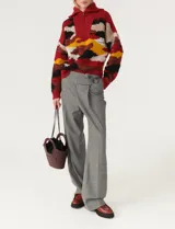 Sweater de punto multicolor con cuello polo con cierre de cremallera, manga larga y corte holgado.