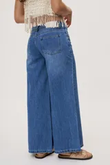 Jean wide leg de tiro medio, con pierna amplia de caída recta, diseño de cinco bolsillos, pasacintos y cierre frontal con botón y cremallera.