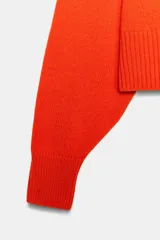 Jersey de lana 100% color azul marino, con cuello redondo, manga larga con hombreras y acabados en rib.