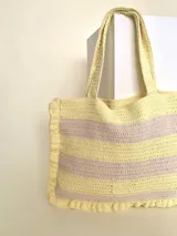 Bolso tipo tote tejido a crochet con hilo de algodón color marrón y crudo, con diseño a rayas horizontales y volados en los bordes.