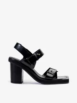 Sandalias negras de cuero vacuno con tiras, detalles de gemelos en bronce, taco de madera y plataforma de EVA.