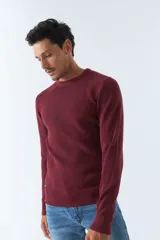 Sweater de punto color bordó, de corte clásico, cuello redondo y mangas largas. Presenta logo bordado en el pecho.