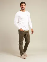 Zapatilla tipo slip-on marca Polanco, color beige con detalles en marrón oscuro en el talón. Presenta una capellada de tela, suela de goma color crema y etiqueta de la marca en el lateral.