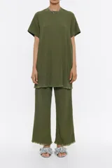 Pantalón tobillero verde militar de viscosa con textura, corte recto, cierre de cremallera lateral y desflecado en el bajo.