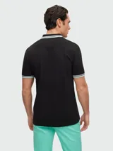 Remera polo de algodón color gris oscuro, marca Boss, modelo Paddy. Corte regular fit, cuello y puños con ribete doble en blanco y gris. Logo bordado en el pecho.