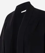 Cardigan de punto color marrón, de corte largo y holgado, con cuello tipo chal, mangas largas y bolsillos delanteros funcionales.