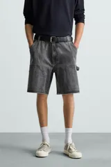 Bermuda relaxed fit confeccionada en tejido de algodón con efecto lavado. Presenta un diseño de cinco bolsillos, bolsillo multifunción en la pernera y tira lateral de estilo carpintero. Cuenta con cierre frontal con cremallera y botón.