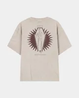 Remera oversize color beige de corte holgado, con estampa en la espalda que representa un esqueleto dentro de un ataúd con rayos oscuros y texto descriptivo.