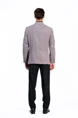 Blazer de pana color gris topo, con solapas de muesca, cierre de dos botones y bolsillo de parche en el pecho con pañuelo decorativo.