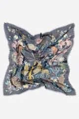 Chal azul marino de forma cuadrada con un diseño estampado de leopardos, palmeras, flores y estrellas. Cuenta con bordes deshilachados.