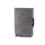 Billetera minimalista gris de cuero sintético con capacidad para varias tarjetas y sistema de eyección automática.