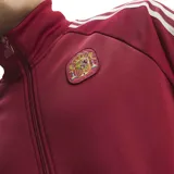 Campera deportiva Adidas de la selección de España, color rojo bordó con las clásicas tres tiras blancas en las mangas, cuello alto y cierre frontal completo. Presenta el logo de Adidas Originals y el escudo de la selección bordados en el pecho.