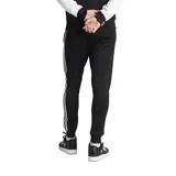 Pantalón de jogging negro con tres rayas blancas a los lados y logo de Adidas bordado en el muslo.